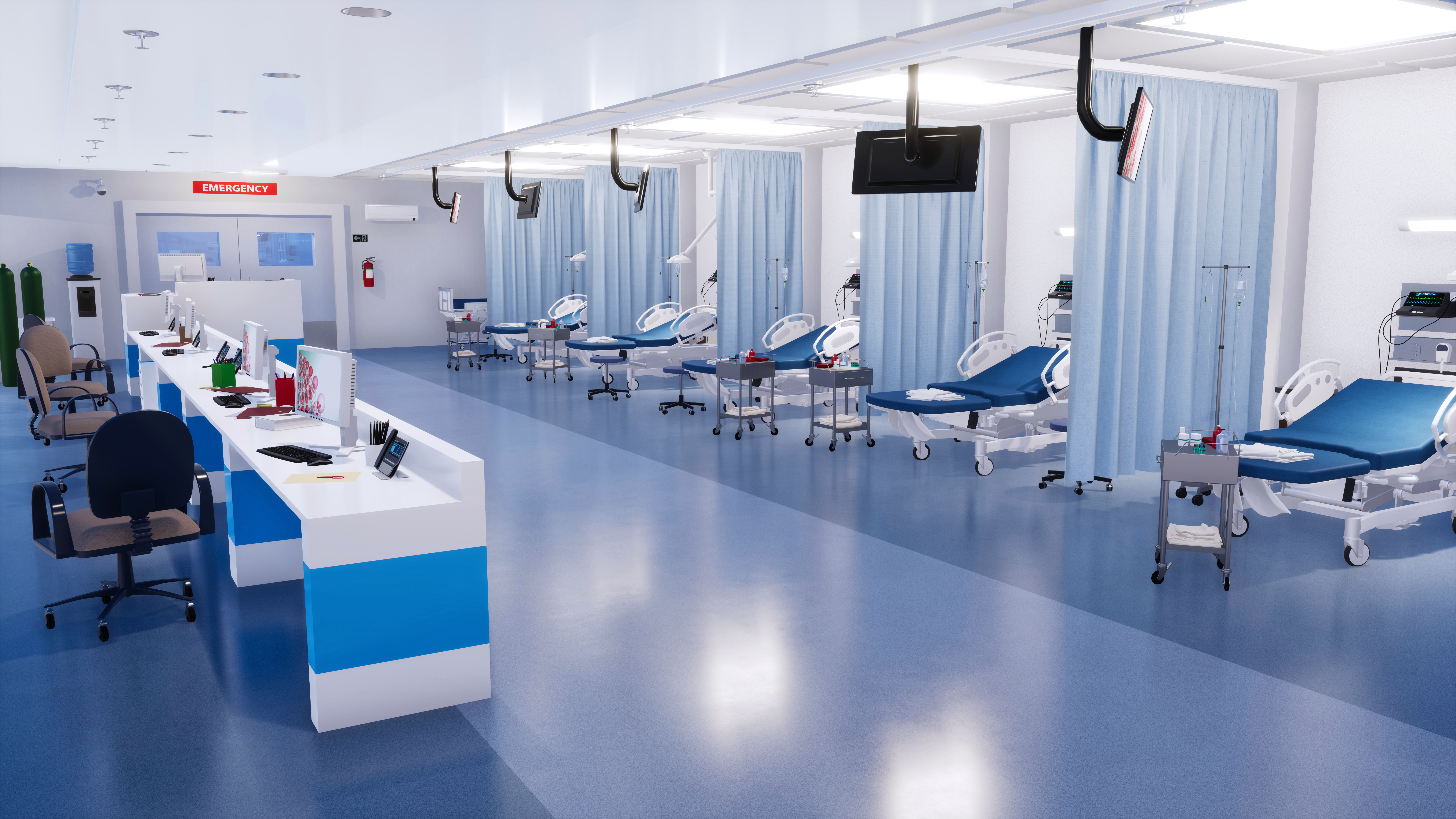 Picture of hospital beds with curtain dividers and nurses station.