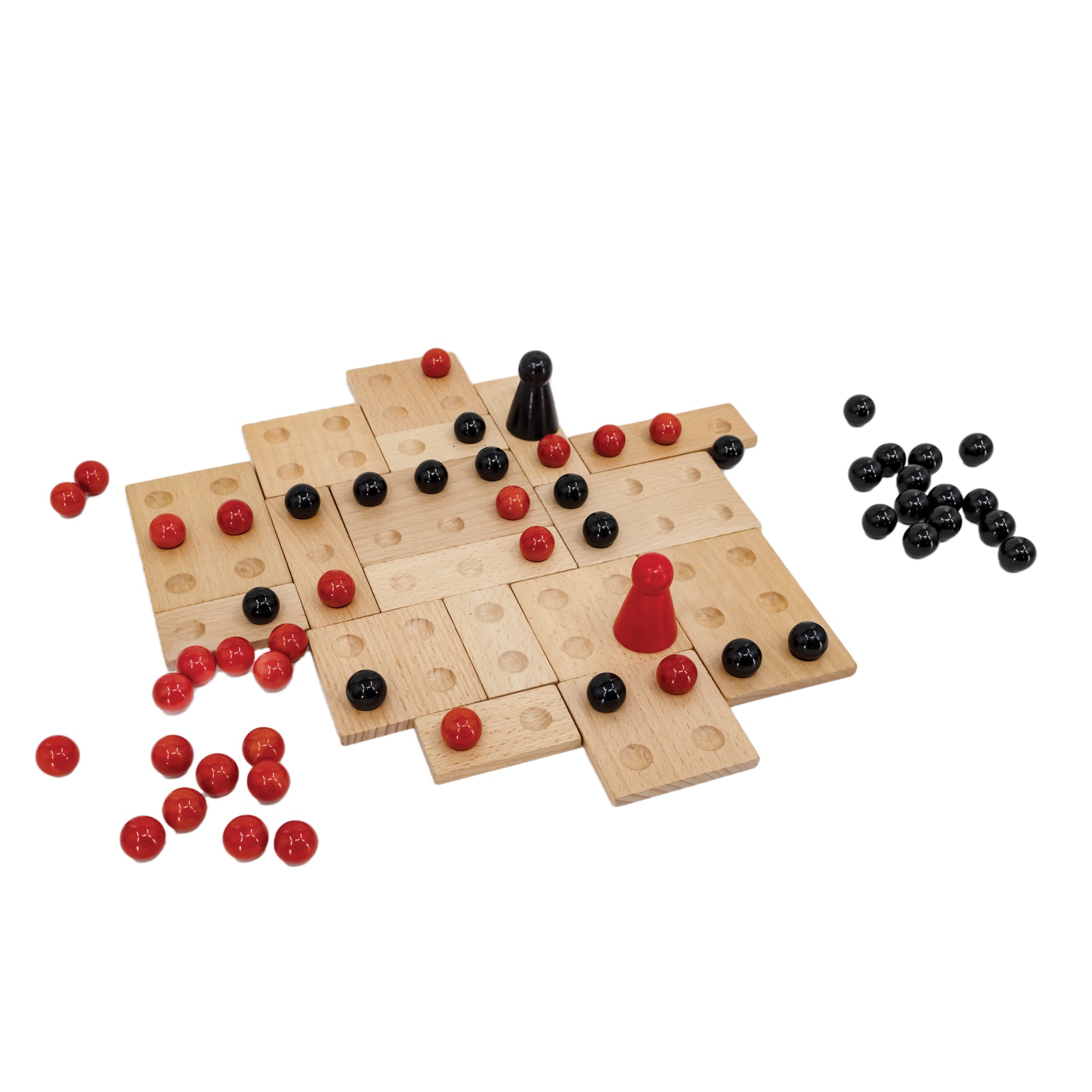 Kulami game in play. There are many square and rectangle wood pieces with divots to place black and red marbles. The wood pieces are placed randomly against each other for form a gapless board. The marbles are randomly placed on top with 2, larger, cone-shaped pieces with a rounded top in the middle; 1 red, and 1 black. There is a pile of black marbles off to the right of the board and a pile of red marbles off to the left of the board.