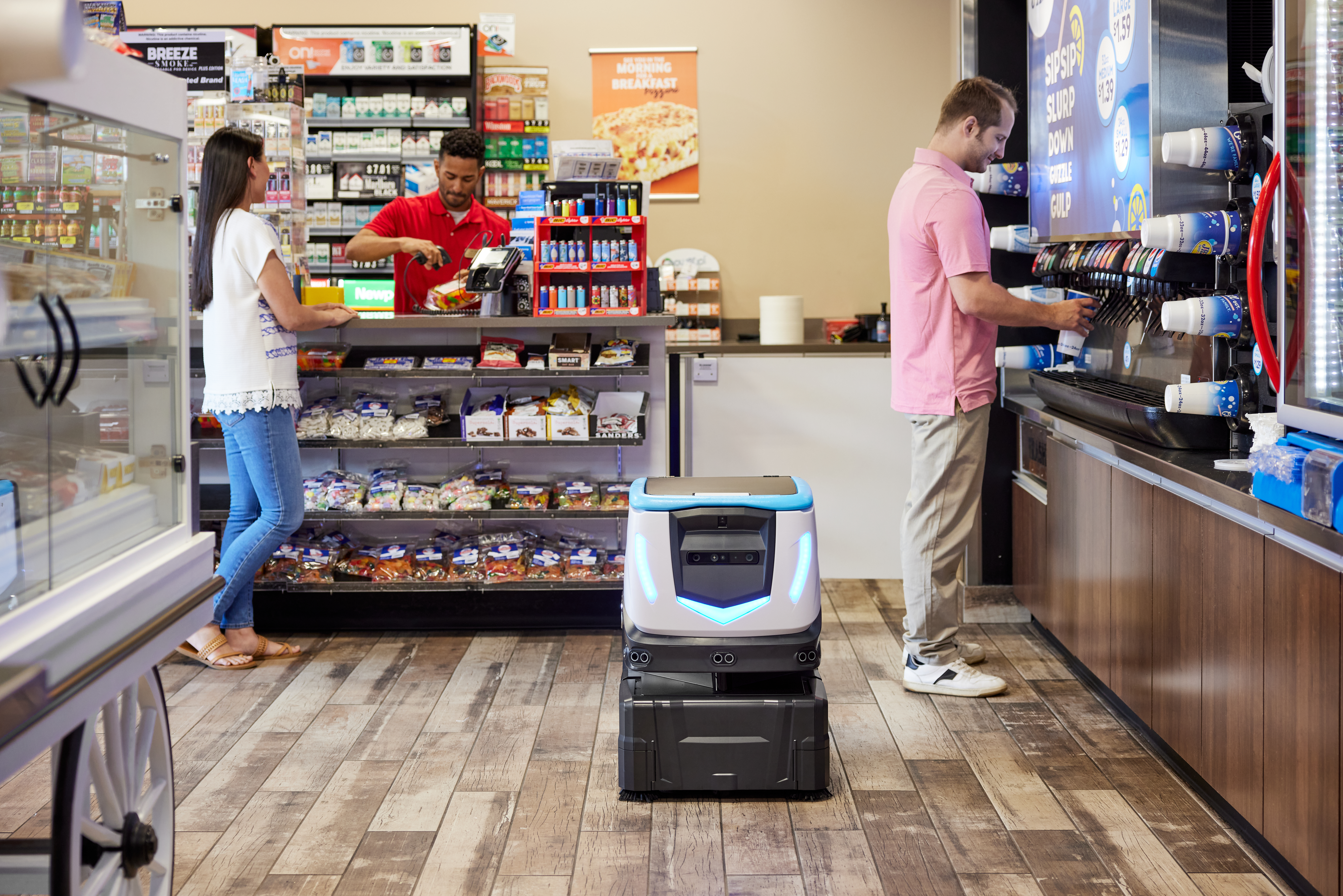 cashier, customer and co-worker working alongside Cobi 18 in a C-Store