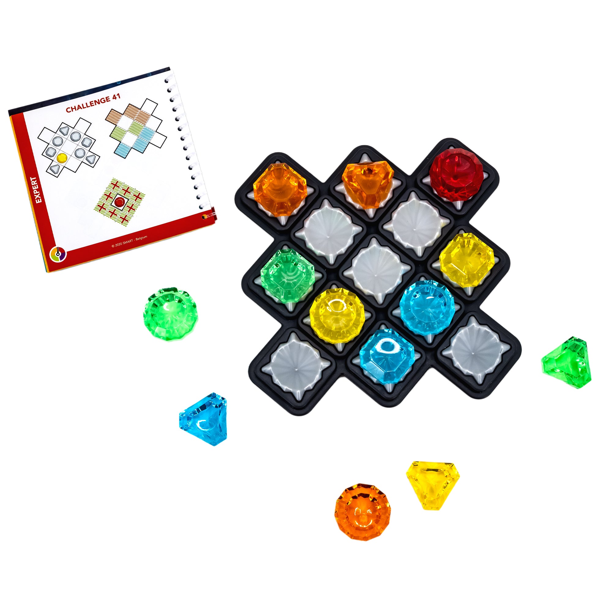 The Diamond Quest Smart Game laid out to show the contents. There is a spiral-bound booklet in the upper-left corner. The game board is to the right has many colored gem pieces in place on the board and several pieces off and surrounding the board. The gem pieces are red, orange, yellow, green, and blue.