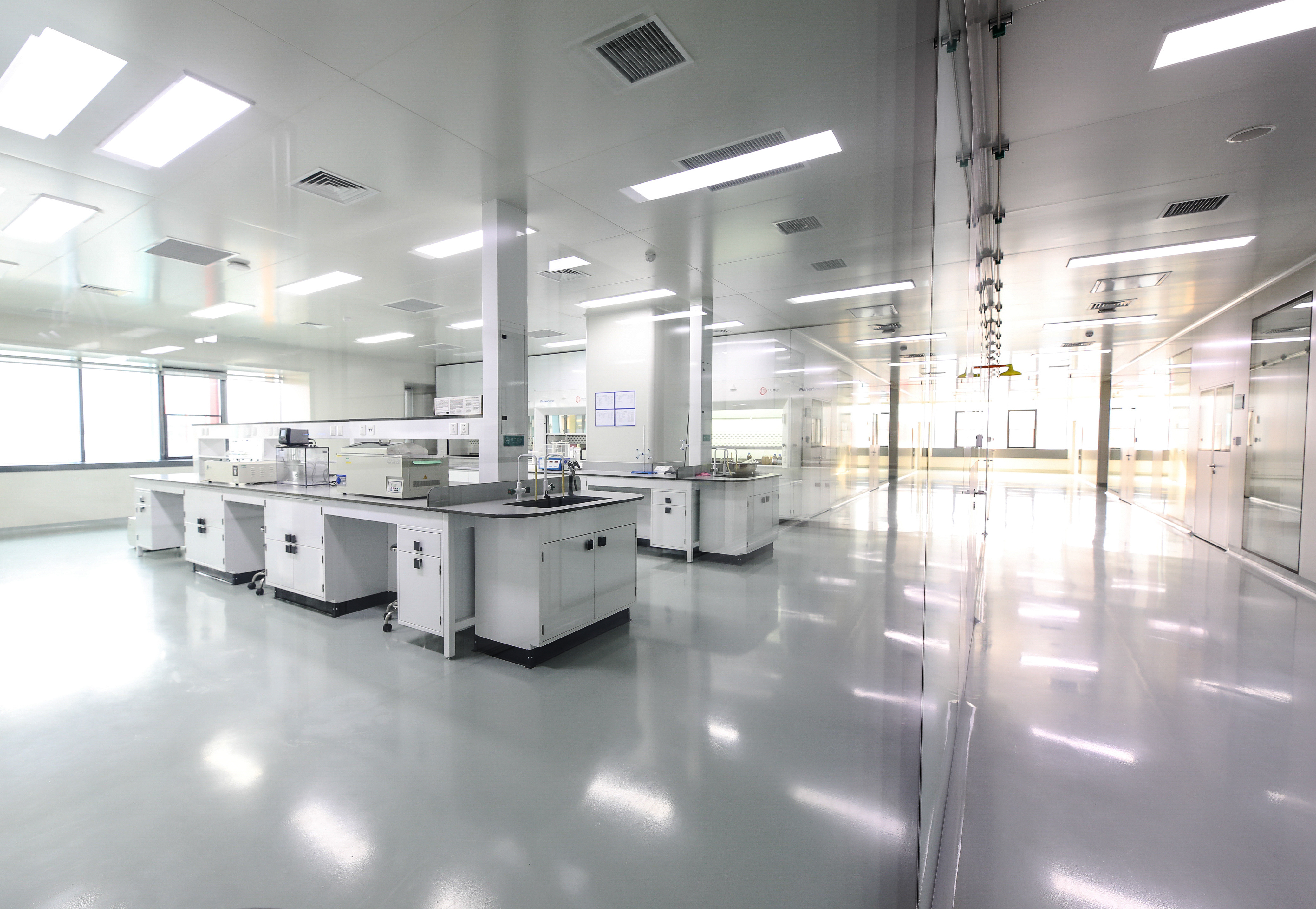 clean manufacturing facility with shiny floors and white cabinetry
