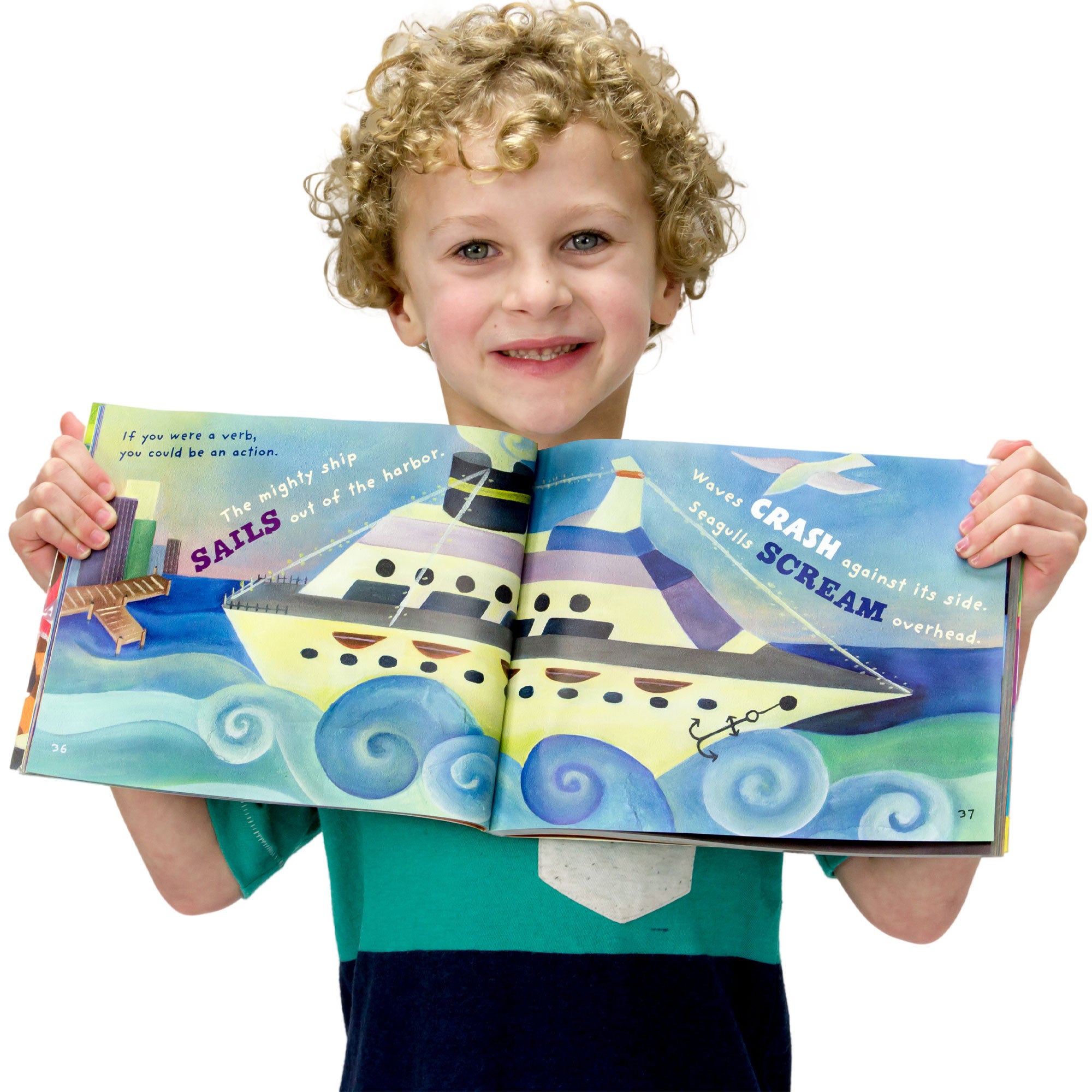 A young, curly-haired, blonde boy is smiling and holding open the Word Fun book to show inside pages. The pages show a large boat, just leaving a city dock, with waves splashing. The text on the pages reads “If you were a verb, you could be an action. The mighty ship sails out of the harbor. Waves crash against its side. Seagulls scream overhead.” The verbs are large, bold, and colored differently than the rest of the text.
