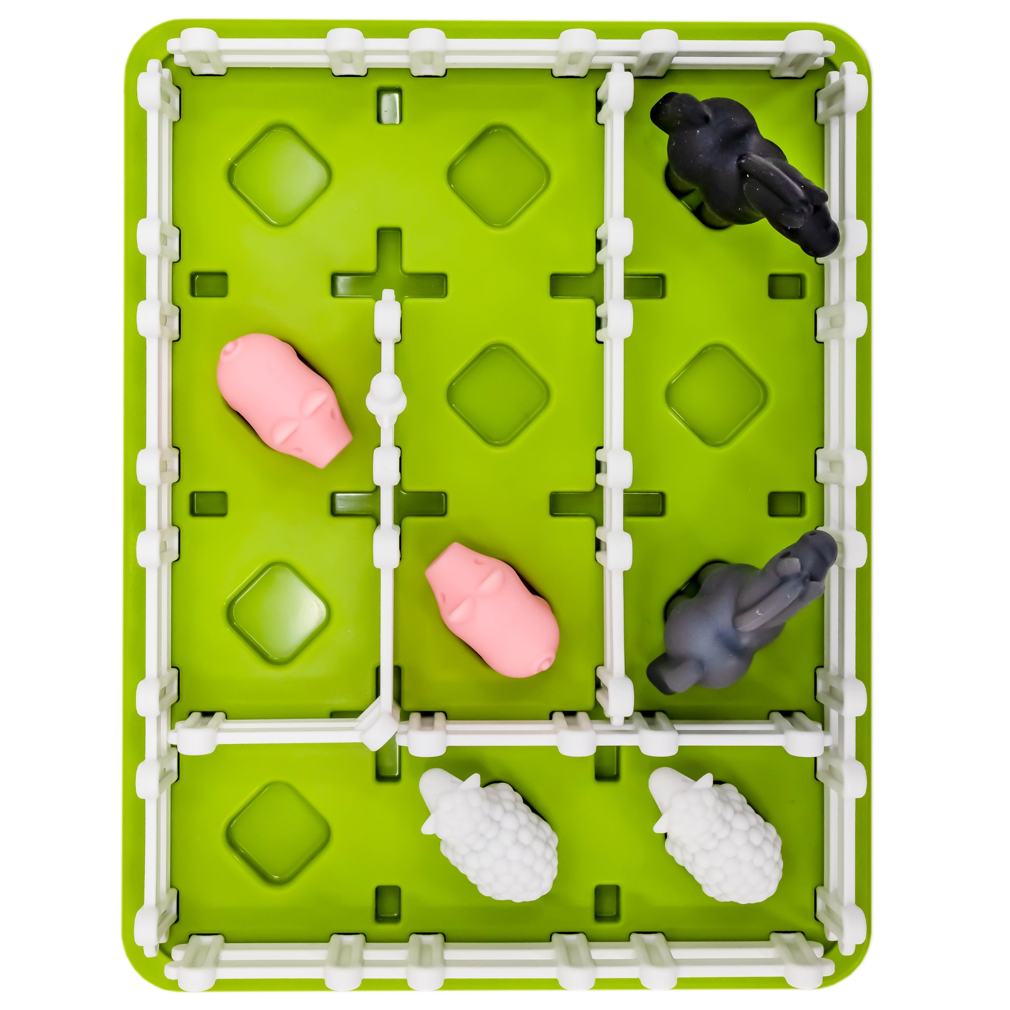 A shot from above of the Smart Farmer game. The game board is green and rectangle-shaped with white fence pieces all around the edge and a few placed in the middle. There are 2 pigs, 2 sheep, and 2 horses pieces on the board inside the fence.