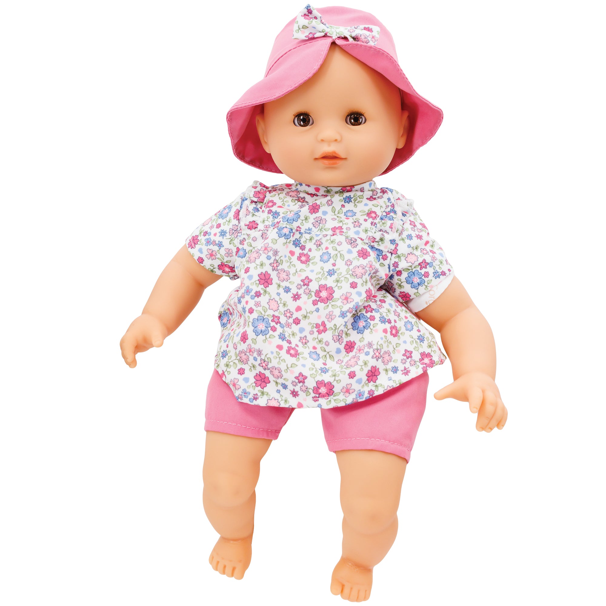 Corolle’s Bebe Coralie. The light skinned baby doll has brown blinkable eyes. She is wearing pink shorts and a floral shirt with a variety of pinks and periwinkle colored flowers in different sizes. She is wearing a pink hat that has a bow in the middle that matches the shirt print.