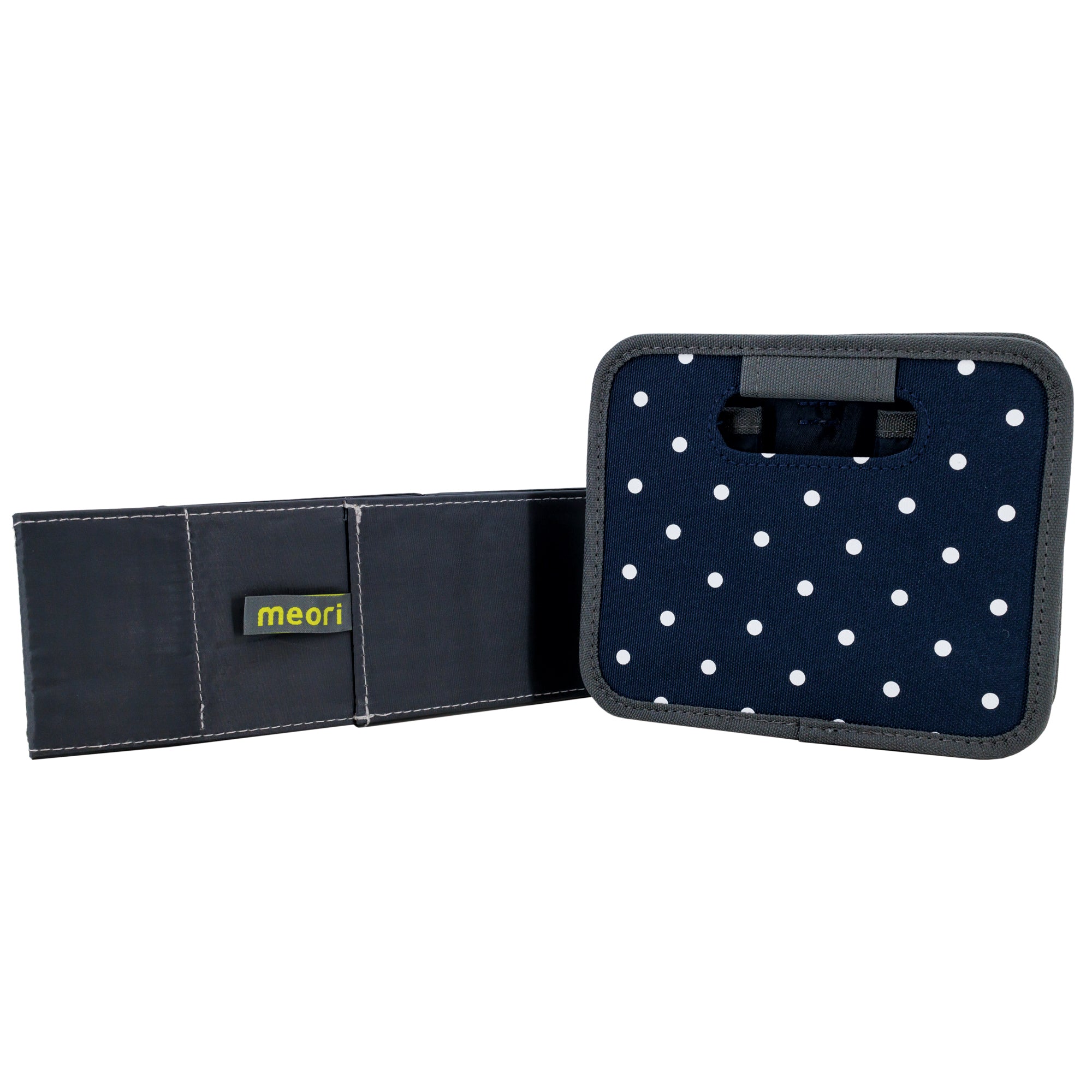 Navy blue with white polka dots colored Meori storage box, folded flat. Navy blue insert propped up against Meori box, also folded flat.