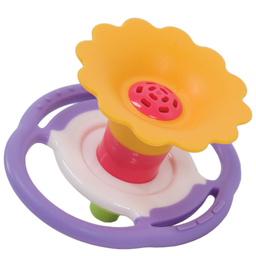 A Flower Whistle toy for a baby. The flower top is a dark yellow with a pink center. The middle portion of the whistle is white in the middle and lavender on the outside. It is round shaped with handles, for smalls hands to hang onto. The whistle portion at the bottom is bright green.