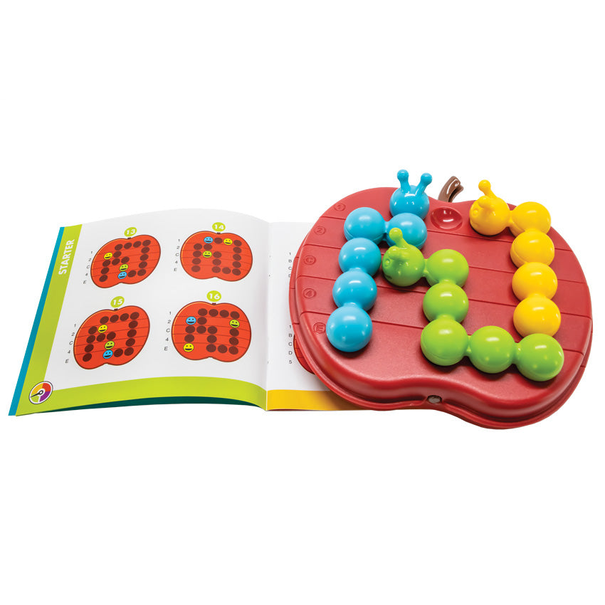 The Apple Twist Smart Game laid out with the green, blue, and yellow caterpillar pieces in place on the board. The apple game board is red with a brown stem and has lines through it, indicating that the pieces on the board can be twisted. The board is laid on top of the instruction booklet, open to show a starter activity setup.