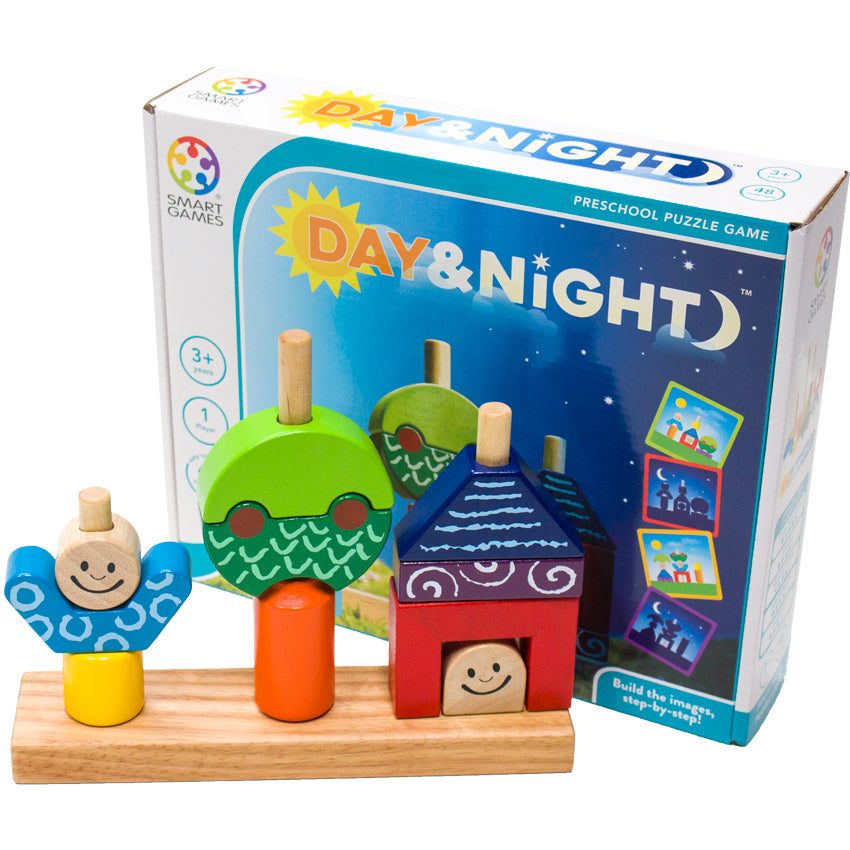 Day & Night game setup in front of the game box. The wooden game has 3 large pegs with pieces placed over the pegs. The first set of shapes forms a person with a yellow bottom, blue top, and smiling face. The second shape shows a tree shape with an orange base, with a dark and light green top. The third shape has a smiling face on bottom, a red box surrounding, a purple rectangle, and a blue triangle at the top, looking like a person in a house. 