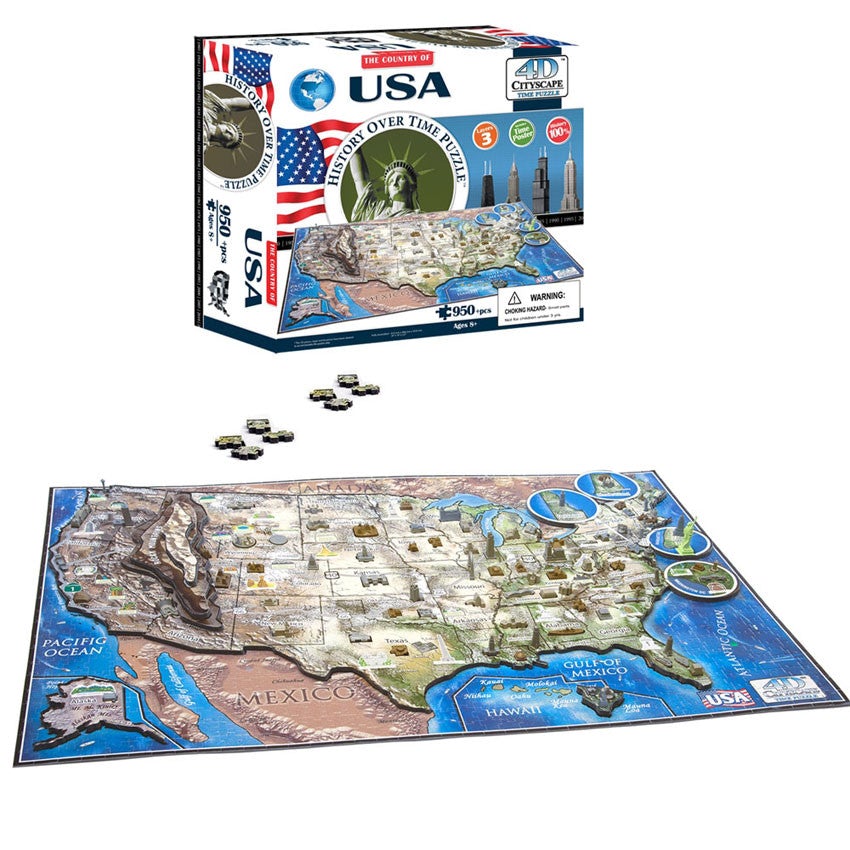 The U S A, History Over Time Puzzle box. The box is mainly white with a blue and white globe in the top-left corner. Across the middle is an American flag, The Statue of Liberty surrounded by a round border with the title inside, and a city scape. Below is the actual puzzle, put together, with several famous building pieces off to the side. Below the box are 4 puzzle pieces and the completed puzzle below that.