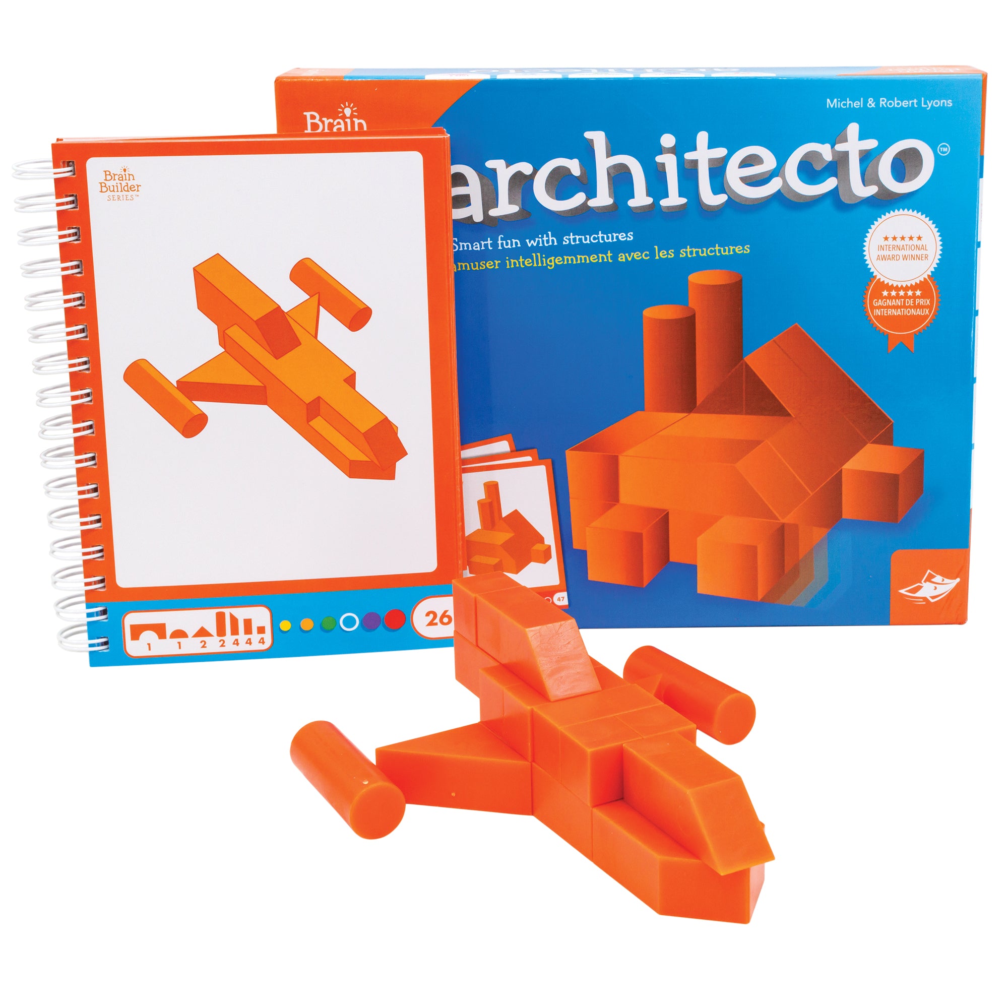 The Architecto game box with a completed project. The box in the back is mostly blue with an illustration in the middle of a factory looking structure created from the orange Architecto pieces. The spiral-bound activity book to the left shows a jet created from the Architecto pieces and the pieces needed to make the structure shown on the bottom. In front is the completed challenge. The pieces seen in the structure are orange triangles, cylinders, rectangles and squares.