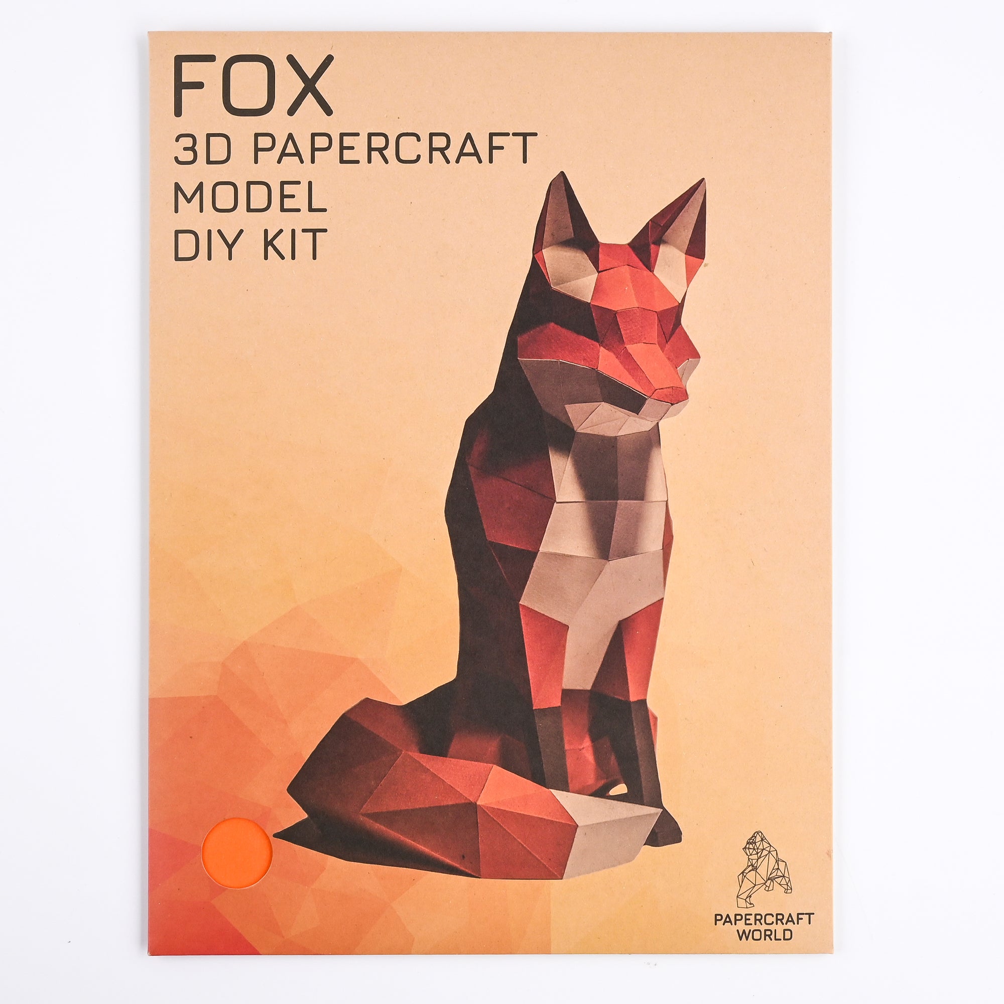 Papercraft fox packaging cover. In the upper-left corner is black text reading: Fox, 3 D papercraft model DIY kit. Background is a faded peach color that gets darker as you look down to the bottom-left corner. You can see faded geometric shapes in the bottom-left corner. In the middle is the finished paper fox. In the right-bottom corner is the Papercraft World text and logo of a geometric black gorilla outline.