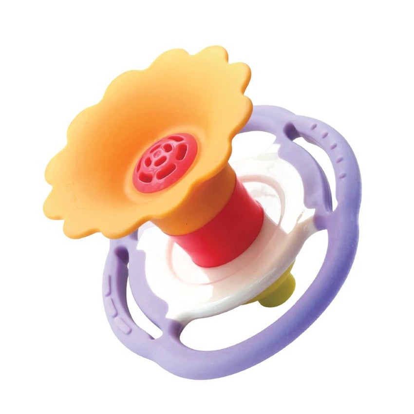 A Flower Whistle toy for a baby. The flower top is a dark yellow with a pink center. The middle portion of the whistle is white in the middle and lavender on the outside. It is round shaped with handles, for smalls hands to hang onto. The whistle portion at the bottom is bright green.