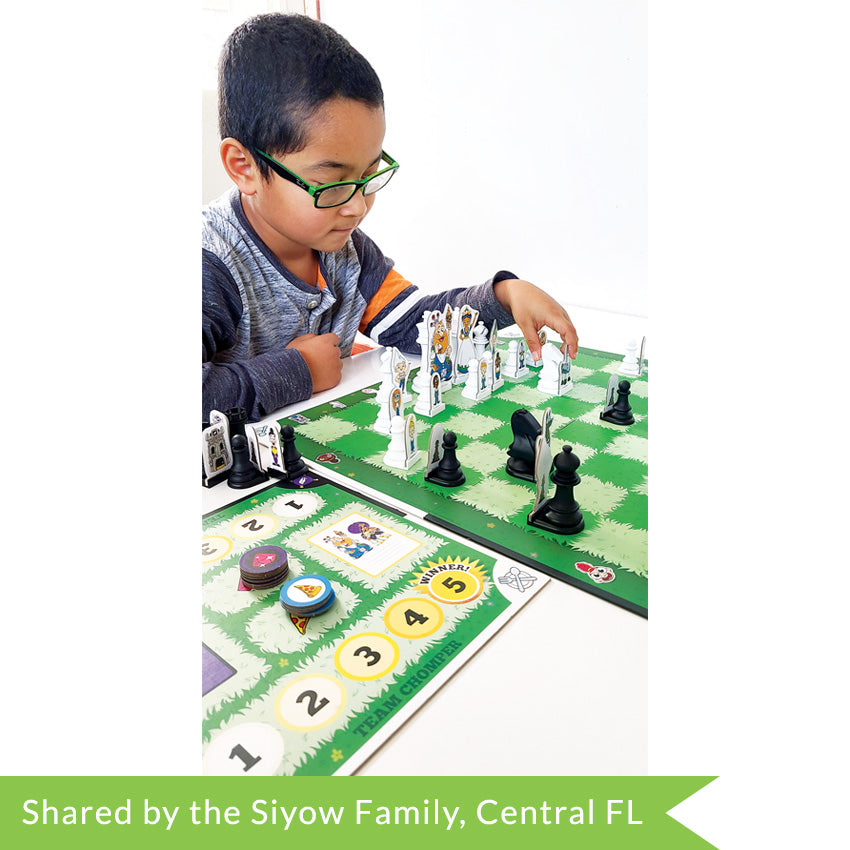 A customer photo of a dark-haired boy is glasses playing Story Time Chess. He is looking down and concentrating on the game on the table in front of him. The game board squares are green grass, alternating darker green and lighter green. The pieces are standard chess shape, but has a character cut-out attached to each piece. There is a scoreboard in the bottom left, numbered 1 to 5 on each side with round tiles stacked in the middle.