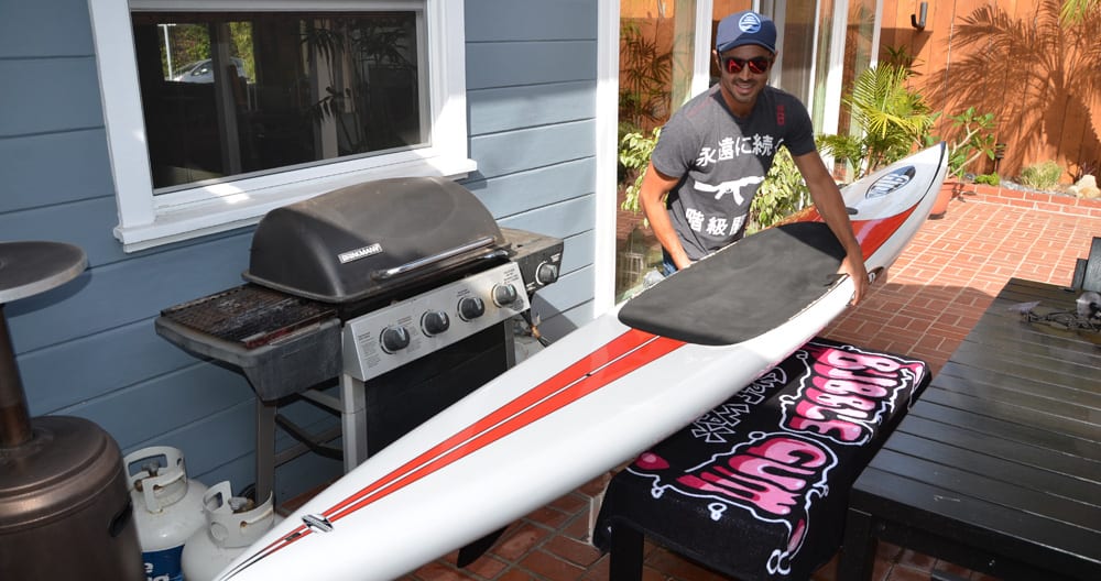 team rider marc prepares himself and the prone paddle board for the race