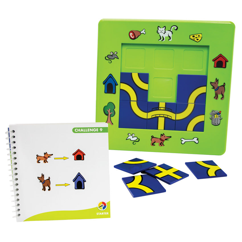 The Cat and Mouse game in play. The game board is bright green with illustrations around the board of pets, outside objects, pet snacks, and pet homes. There are blue and yellow square pathway pieces placed in the middle of the board. There are 4 more square pieces laid out in front of the board, waiting to be placed on the board. In front is the instruction booklet, open to show a challenge. 