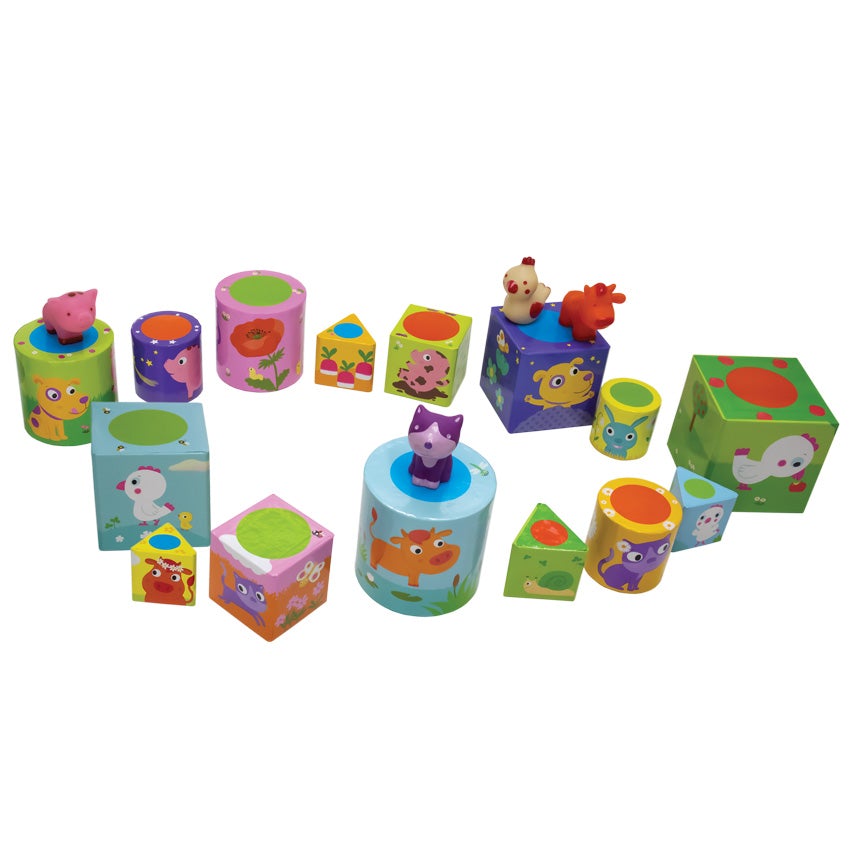 Animal Playground game pieces placed In the shape of a wonky oval. The square, rounded, and triangle shaped boxes are in many colors with illustrations of animals and flowers on them. The plastic animal figures are randomly placed on top of the box pieces.