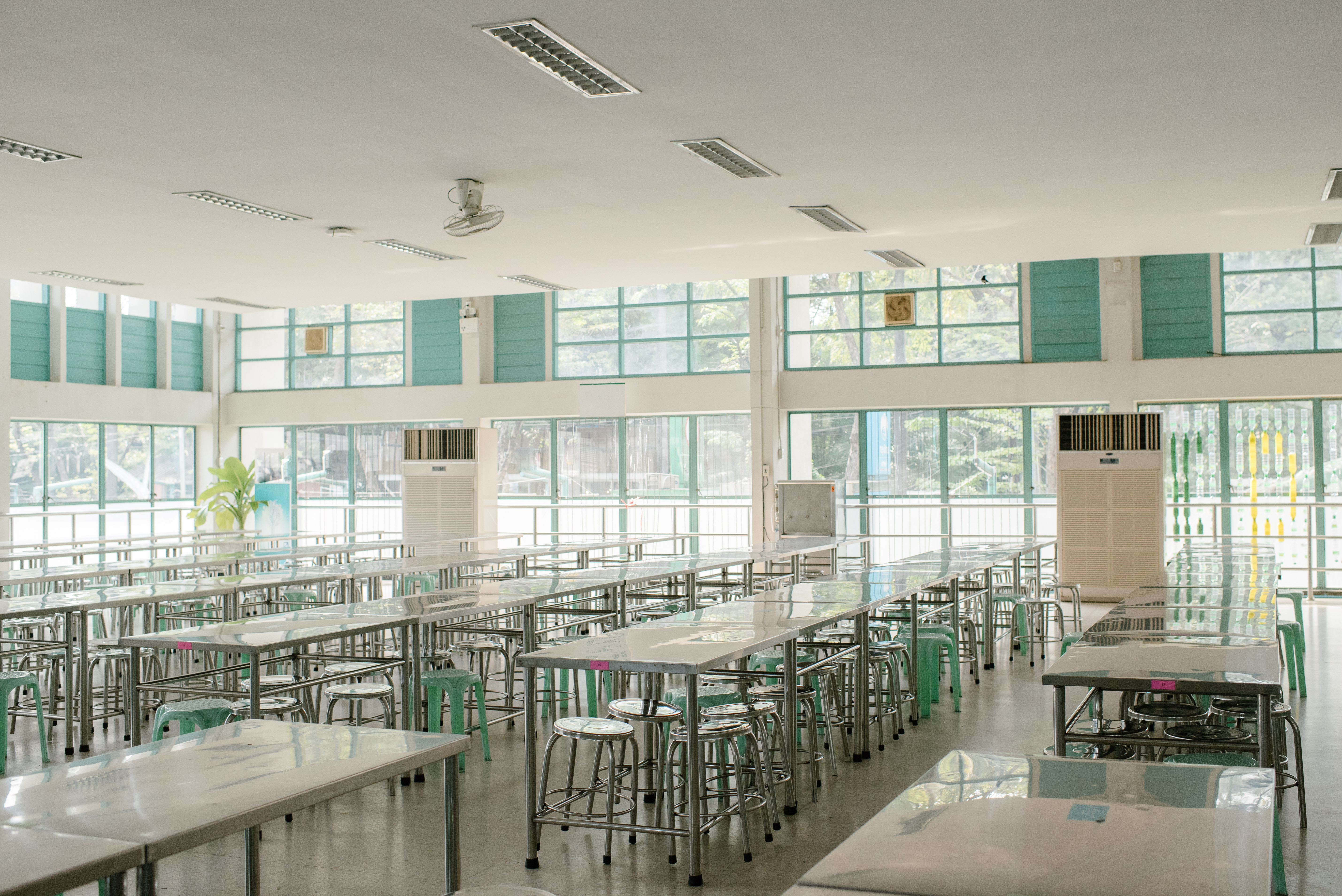 bright , shiny, and clean classroom with tall tables and green chairs