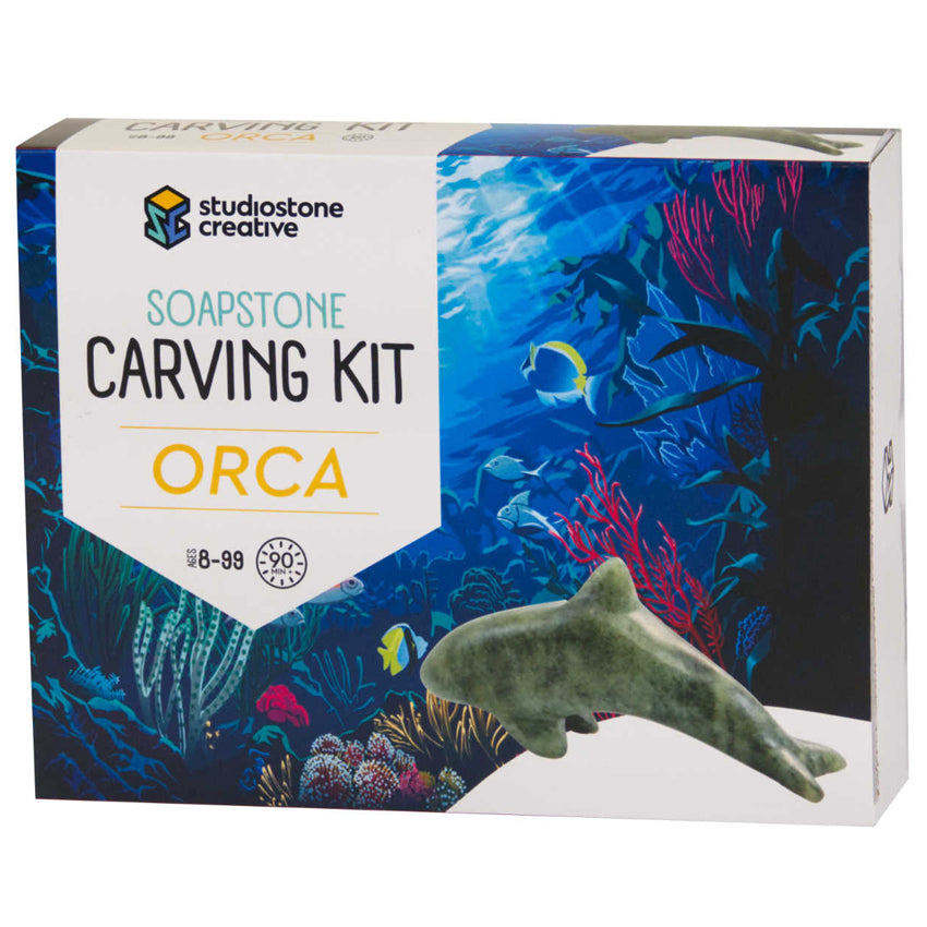 Orca Soapstone Carving Kit box with an orca figuring pictured with an ocean scene background.