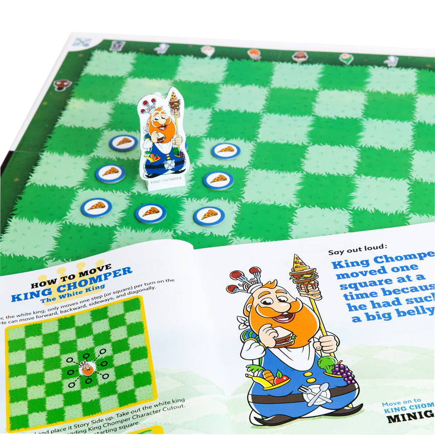 Story Time Chess game board and instructions laid out. The game board squares are green grass, alternating darker green and lighter green. On one of the squares is the King piece. He is surrounded by round tokens with a pizza slice on them. In the instruction book, is the same King image as on the piece. He is large with a big orange beard and getting ready to eat a sandwich in his right hand while holding a staff with skewered food on it in his left.