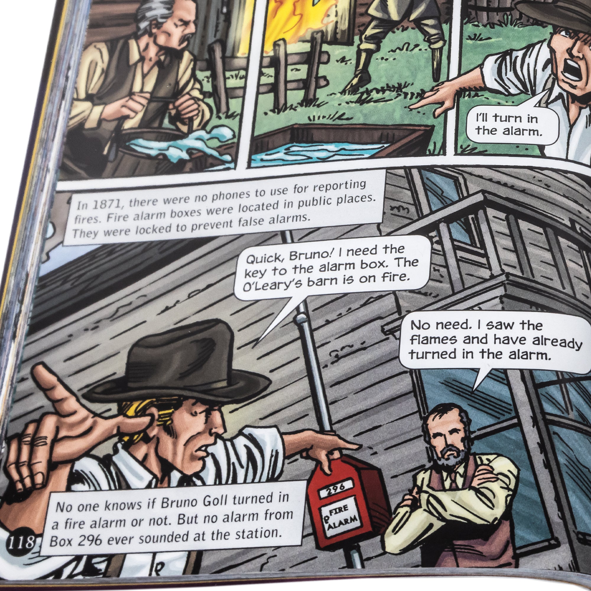 Disasters in History, a graphic novel collection open to show a close up of one of the inside pages. The page shows a barn on fire and a man rushing to turn on the fire alarm, but it was locked. In 1871, you had to have a key to open them. A man asks another man to turn it on, and he said he did, but the alarm never sounded at the station. The book is a comic book style layout with squared illustrations and talk bubbles.