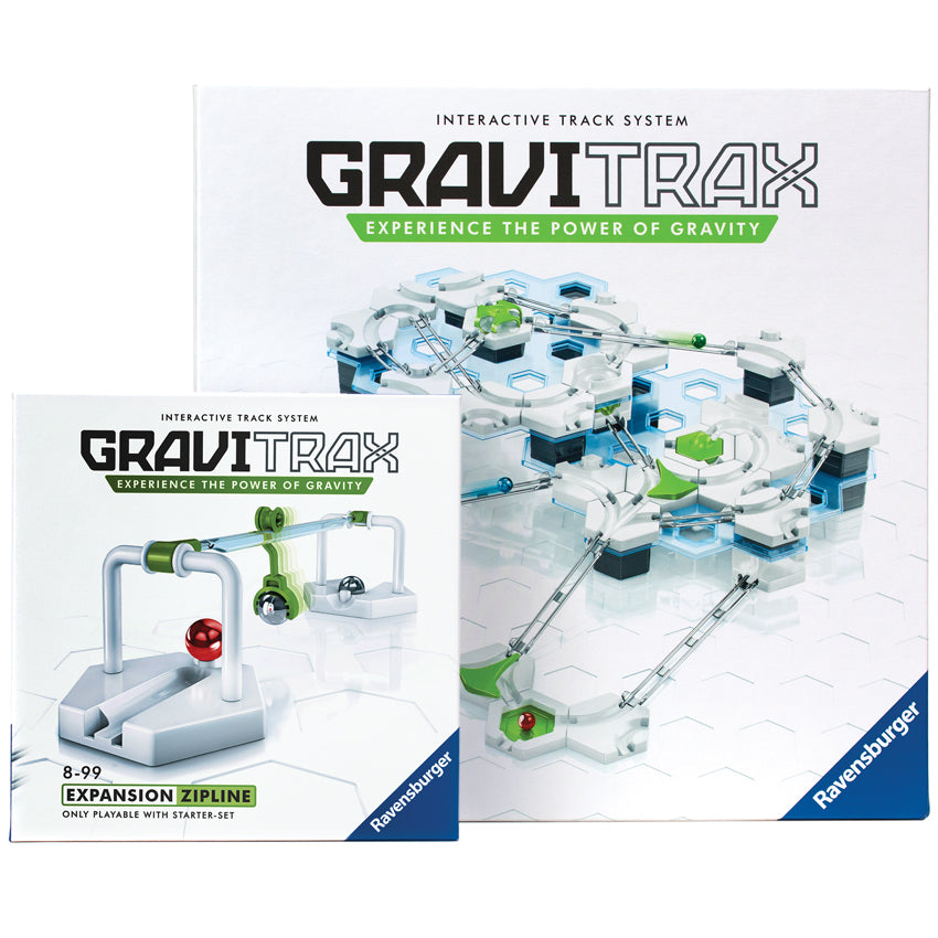 The GraviTrax Deluxe Set boxes with the zipline piece put together in front of the boxes. The box in the back is large with the main GraviTrax game in play on the cover. The smaller box in front, and to the left, is the zipline add on expansion with the completed item put together on the box.  The pieces on the box are mainly hexagon shapes, with rails for marble pieces to roll through.