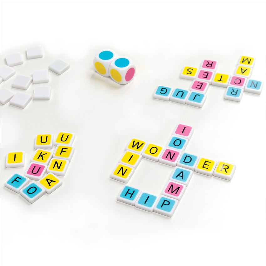 Candygrams game in play. On the left are letter tiles, face down, to show an empty white back. Under the white tiles are face-up tiles, showing a letter on each with a colored background of pink, yellow, or blue. To the right, on the top and bottom, are crosswords. The crossword words on top are jug, jeer, notes, and roam. The crossword words on bottom are ion, wonder, win, damp, and hip. In the middle-top are 2 dice with alternating colored dots on each side, in red, yellow, and blue.