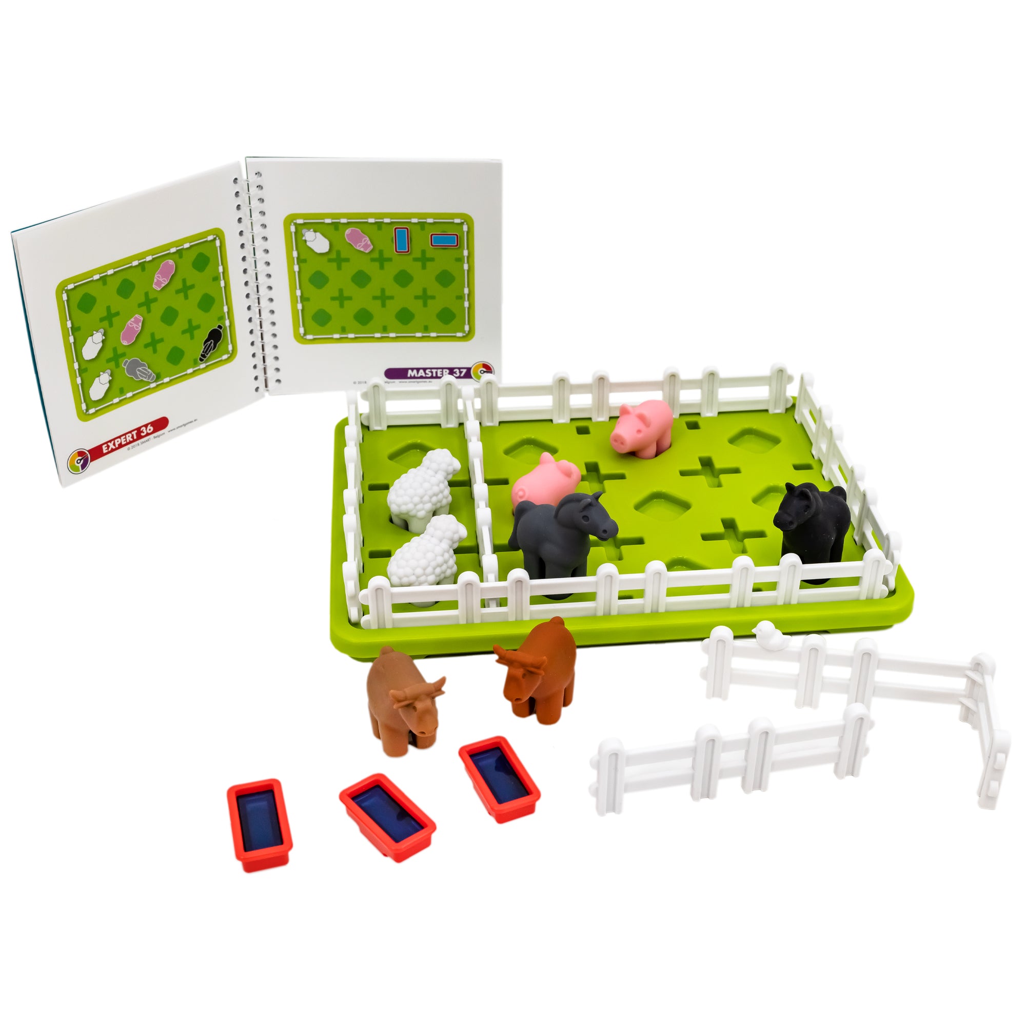 Smart Farmer game components. The game board is green and rectangle-shaped with white fence pieces all around the edge and a couple in the middle. You can see pigs, sheep, and horses inside the fence. Off to the side are 2 cows, more fence pieces, and 3 water dishes. In the back, to the left, is the instruction manual showing 2 challenges.