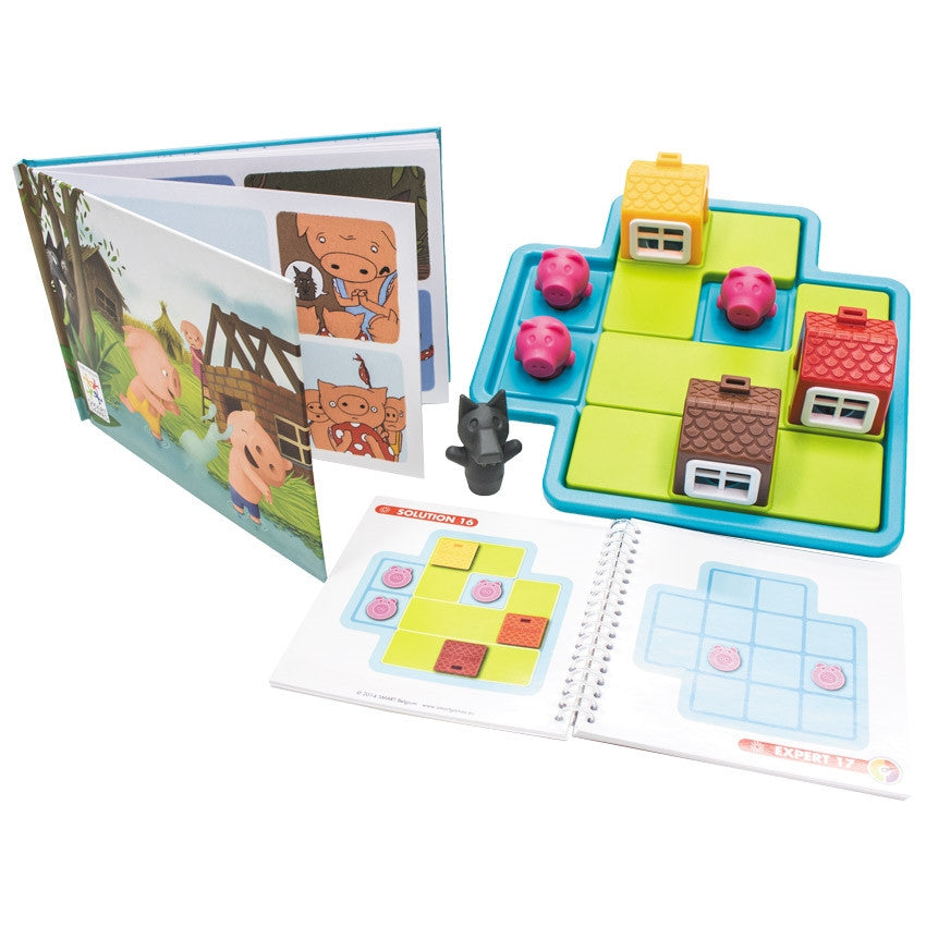 Three Little Piggies game contents spread out. On the left is the hardcover storybook that comes with the game. On the right is the game board with pieces. The game board is light blue with playing pieces on the board, including; a red house, a yellow house, a brown house, and 3 pigs. There is a wolf off to the left of the board. Below the board is the instruction booklet open to show a solution and a new challenge.