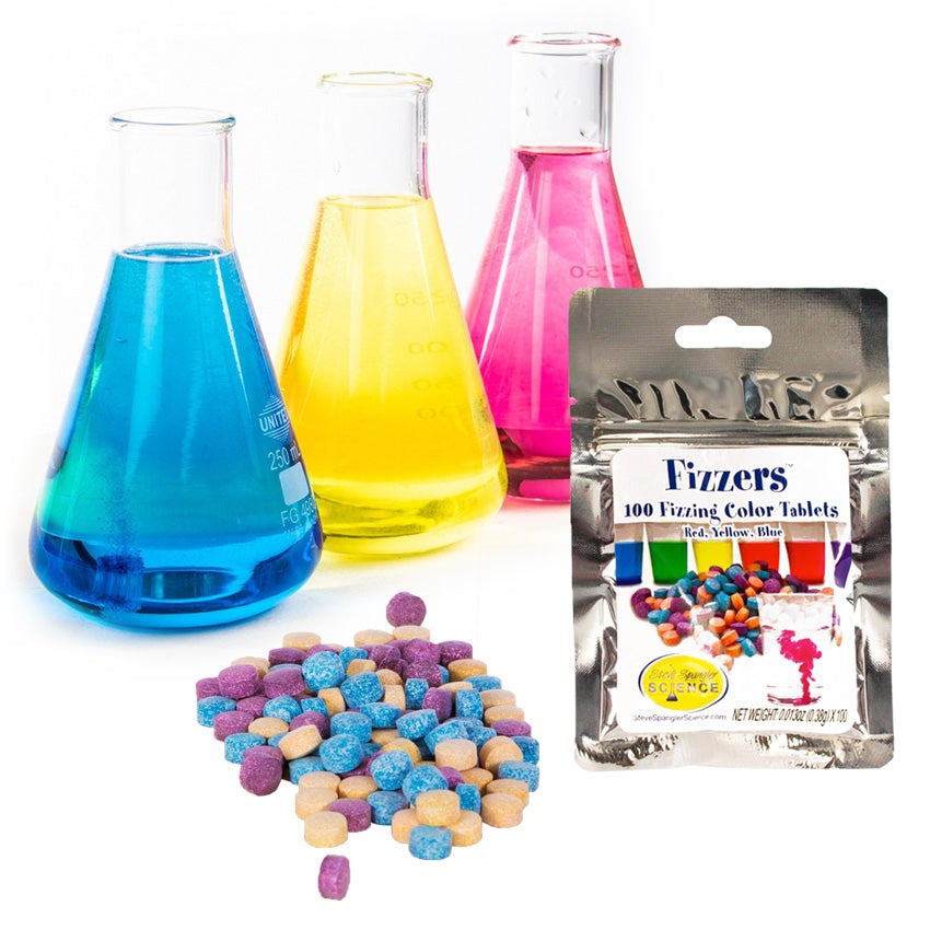 On the left are 3 beakers with blue, yellow, and pink colored water lined up diagonally. In front of the beakers and to the right is the Foil colored Color Fizzers pouch. On the package is a sticker label showing colored water in glasses with tablets in front and a glass with water in the process of being colored by a red tablet and the Steve Spangler Science logo located in the lower-left of the label. On the bottom-left is a pile of orange, blue, and purple color tablets.