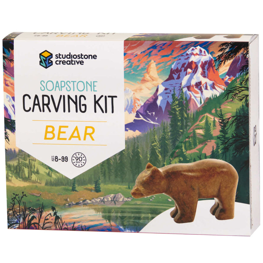Product box of the bear Soapstone Carving Kit.  Package image is of the bear carving in from of an illustrated lake, trees, and mountain in the background.