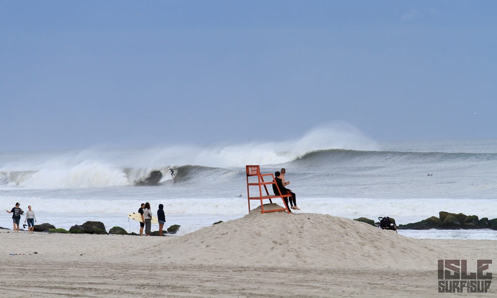 beach goers marvel at the giant east coast swell from the sand