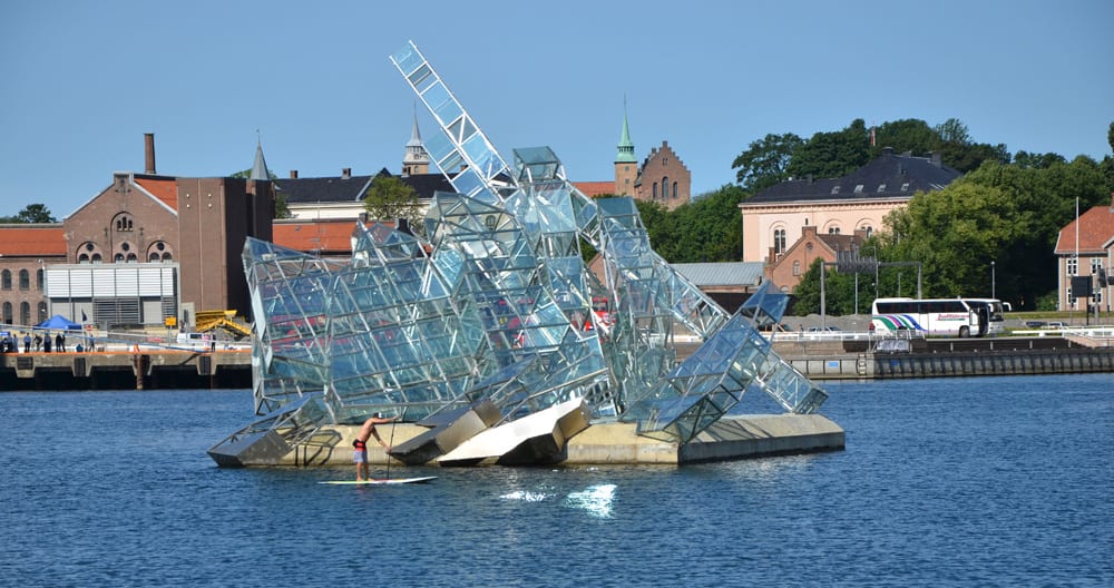 paddling by a beautiful floating sculpture in front of the oslo opera house