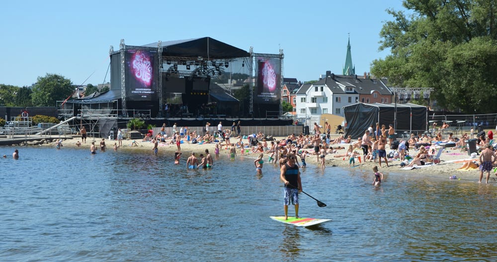 Dirk paddle boarding around Bystranda Beach and The Palmesus Music Festival