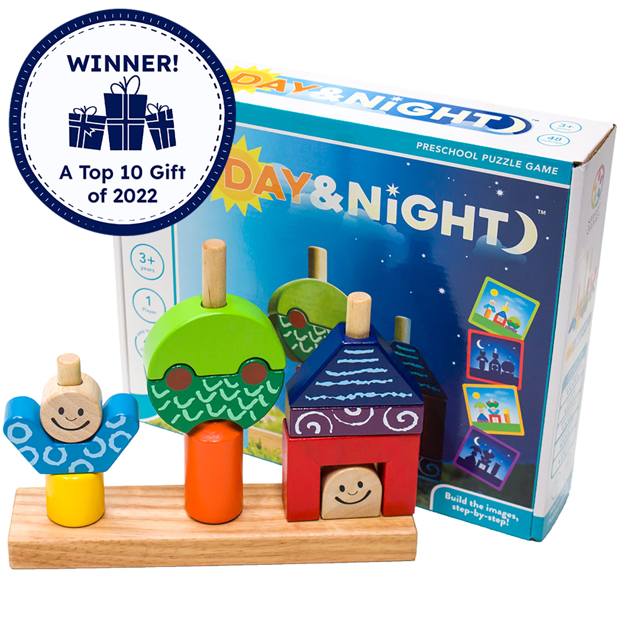 Day & Night game setup in front of the game box. The wooden game has 3 large pegs with pieces placed over the pegs. The first set of shapes forms a person with a yellow bottom, blue top, and smiling face. The second shape shows a tree shape with an orange base, with a dark and light green top. The third shape has a smiling face on bottom, a red box surrounding, a purple rectangle, and a blue triangle at the top, looking like a person in a house. A “Winner! A top 10 gift of 2022” badge is in the top-left.