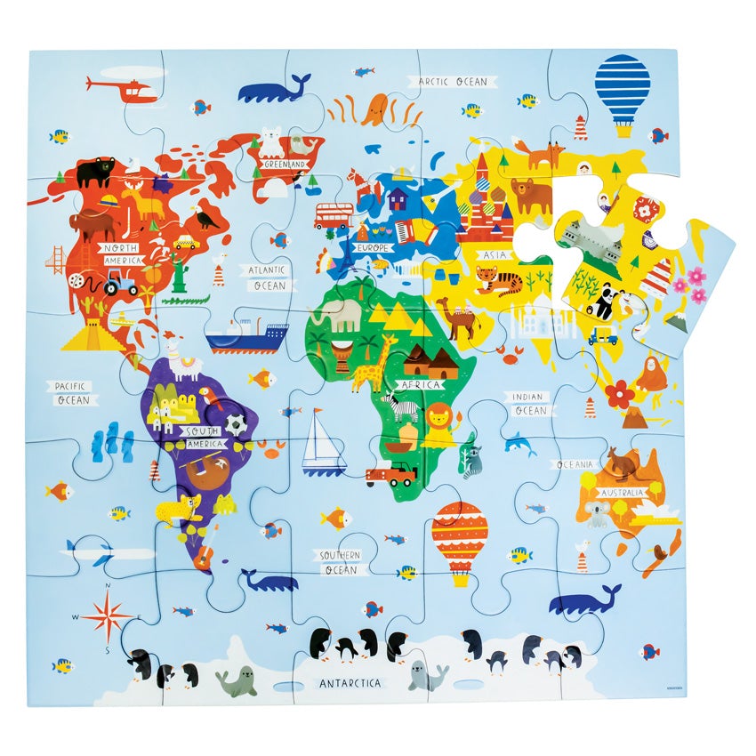 Jumbo Puzzle, Map of the World. The 25 piece puzzle is completed, with 1 pieces near the top-right nearly in place. The map is mainly light blue with each continent a different color and many animals and vehicles placed all over the top. North America is red, South America is purple, Africa is green, Europe is blue, Asia is yellow, and Australia is orange. Antarctica is white with penguins and seals.