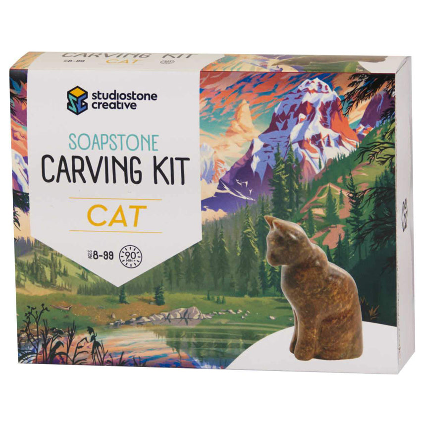 Product box of the cat Soapstone Carving Kit. Package image is of the bear carving in from of an illustrated lake, trees, and mountain in the background.