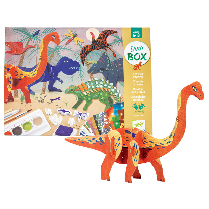 The Djeco World of Dinosaurs box with a completed orange Brachiosaurus project in front. The box shows palm trees in the background with dinosaurs coming out of the woods and congregating in the middle. The dinosaurs are a brachiosaurus, T Rex, pterodactyl, triceratops, and ankylosaurus. The bottom of the box shows contents of the kit. Age recommendation is 6 to 10.