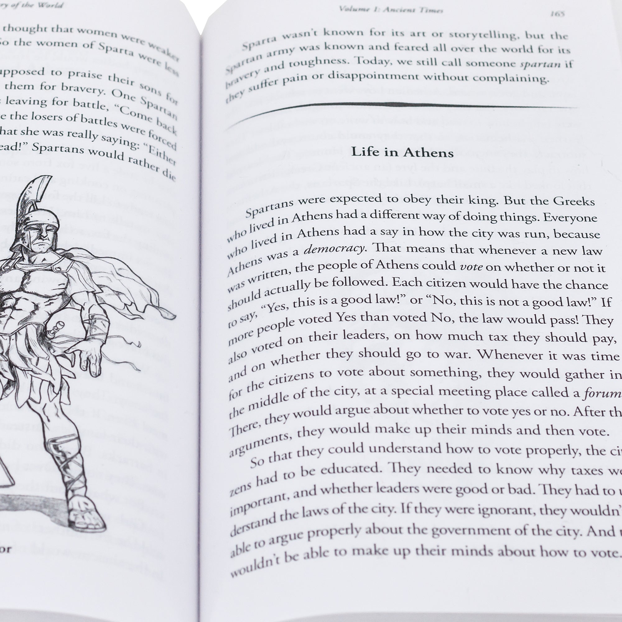 A close up shot of The Story of the World, Volume 1, Ancient Times open to show inside pages. On the left page under some text, is a black and white illustration of a Spartan Warrior. On the right is more text and a title reading “Life in Athens,” then more text.