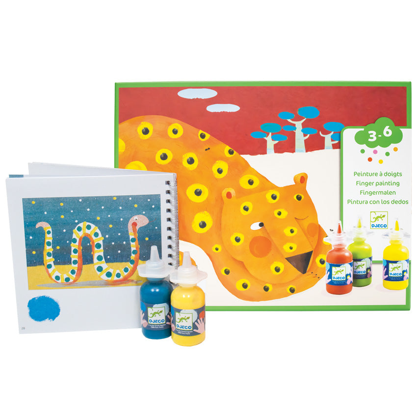 The Djeco Finger Tracks set box featuring the leopard project. It shows a leopard sleeping with one eye peaked open. Behind him are blue trees in a red sky. Over the picture, in the bottom-right corner, it shows some of the paint bottles. To the left, and in front, of the box are 2 paint bottles, blue and yellow, in front of the instruction book open to show the snake project.