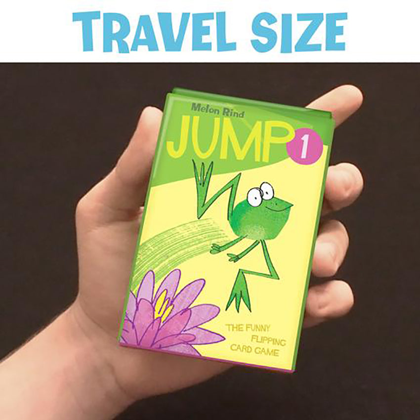 Child's hand holding the Jump 1 game with a dark brown background. Text  on the top of the image says "travel size".